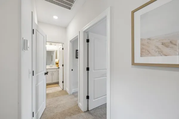 a view of a hallway with paintings on the wall