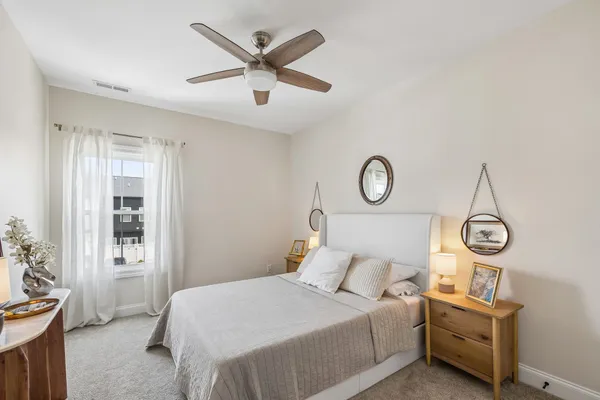 a bedroom with a large bed and a chandelier