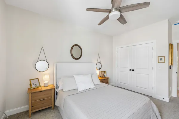 a bedroom with a bed and chandelier