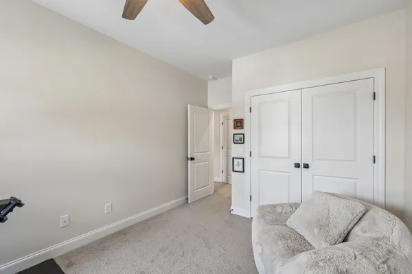 a spacious bedroom with a bed and closet