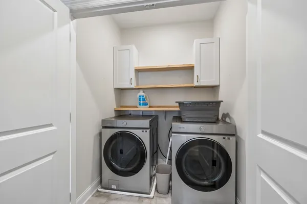 a utility room with sink dryer and washer