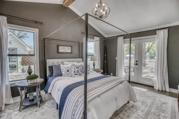 a bedroom with a large bed and a window