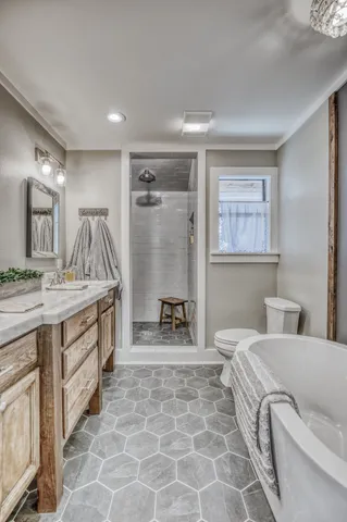 a spacious bathroom with a double vanity sink a mirror and a bathtub