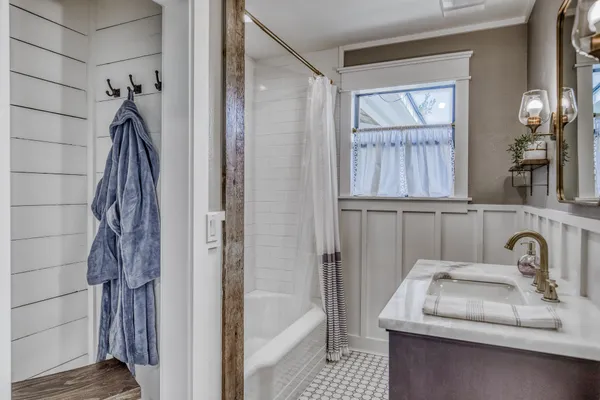 a view of bathroom with a sink and mirror