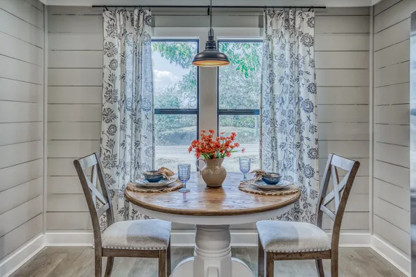 a view of a dining room with furniture and window
