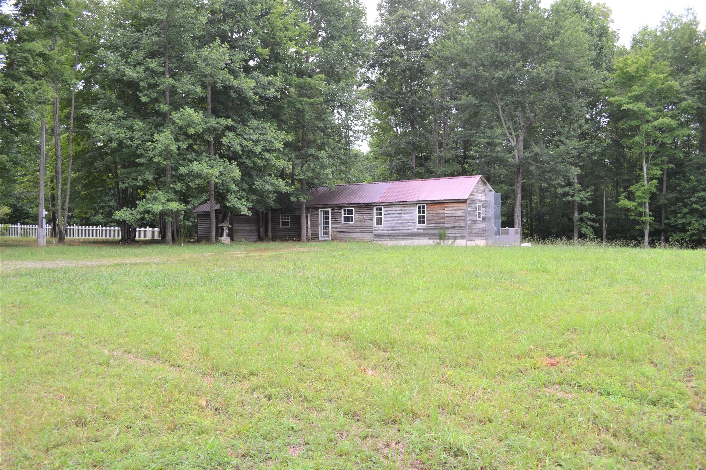 9699 Chestnut Ridge Road Lynchburg, TN 37352 - Photo 2 of 11 a view of a house with a yard and sitting area