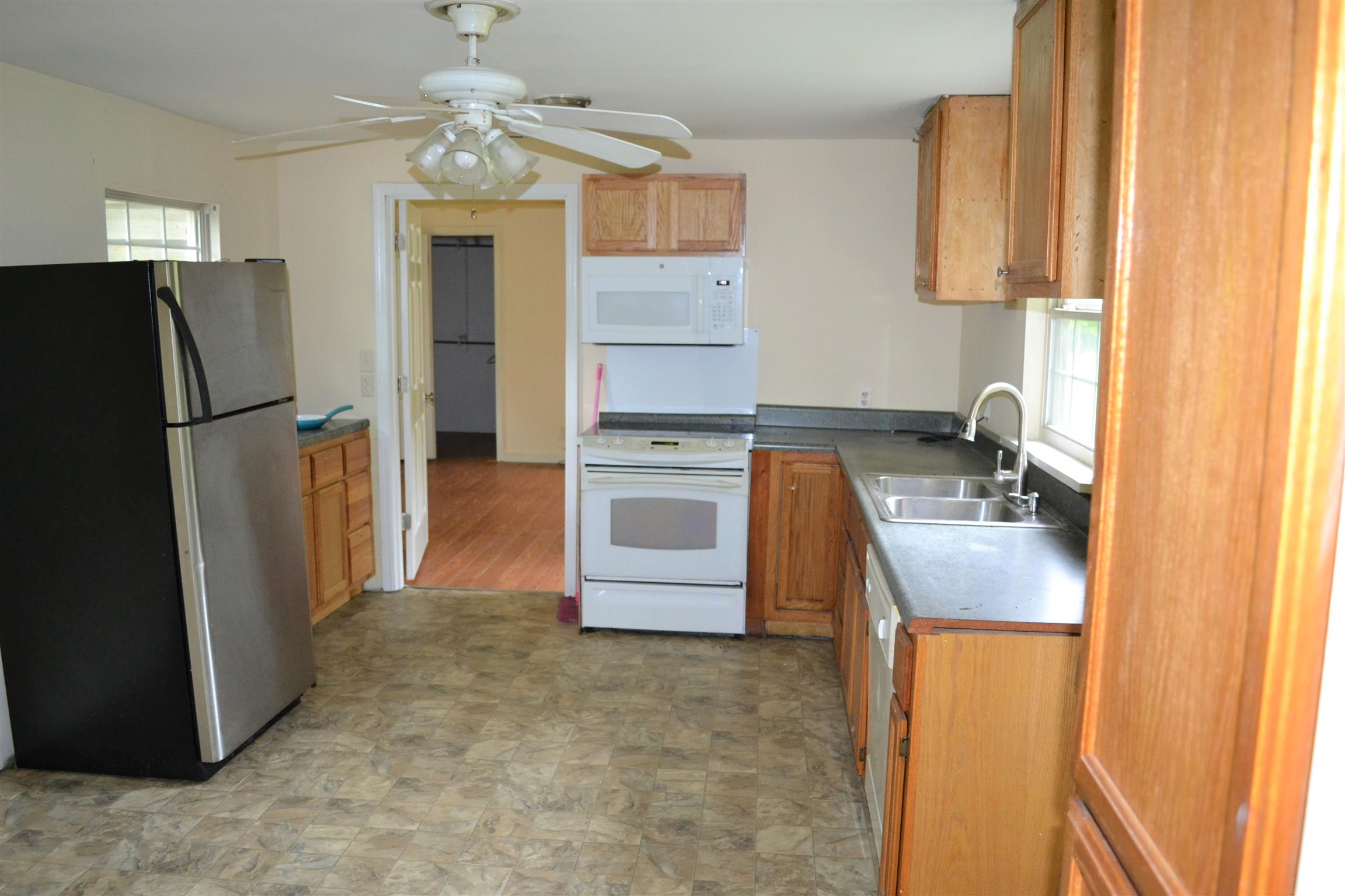 9699 Chestnut Ridge Road Lynchburg, TN 37352 - Photo 3 of 11 a kitchen with a refrigerator sink and cabinets