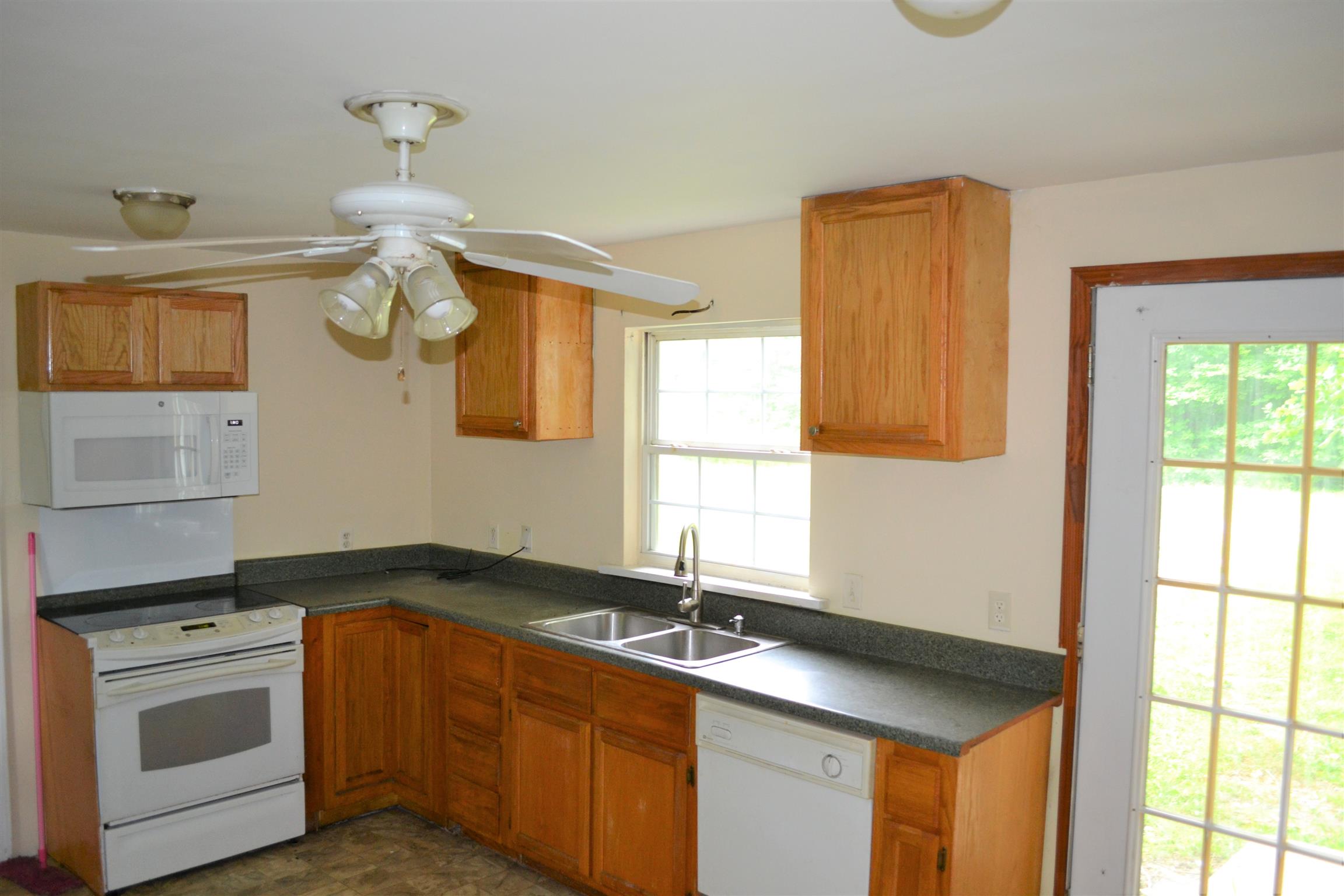 9699 Chestnut Ridge Road Lynchburg, TN 37352 - Photo 4 of 11 a kitchen with a sink and a stove top oven