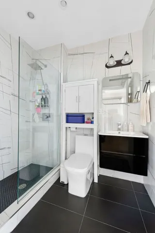 a bathroom with a shower and a mirror
