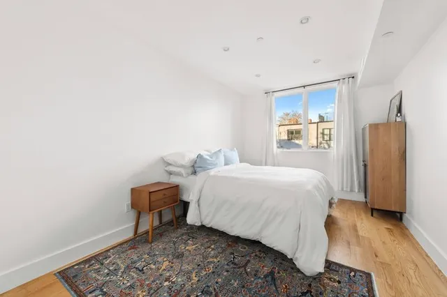 a bed room with a bed and a window