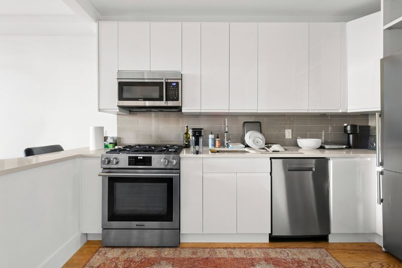 725 Lafayette Avenue, Unit 2B Brooklyn, NY 11221 - Photo 6 of 8 a kitchen with stainless steel appliances granite countertop a stove a sink and a microwave
