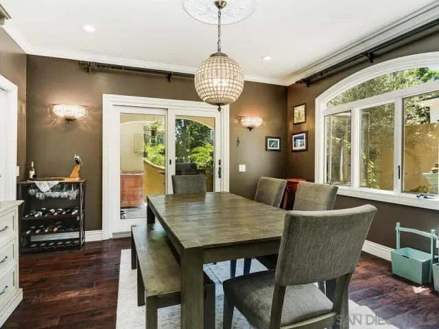 a dining room with furniture window and wooden floor