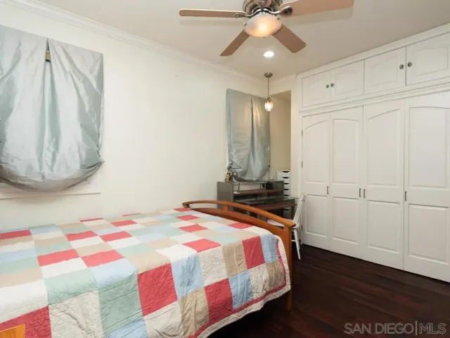 a bedroom with a bed and a mirror