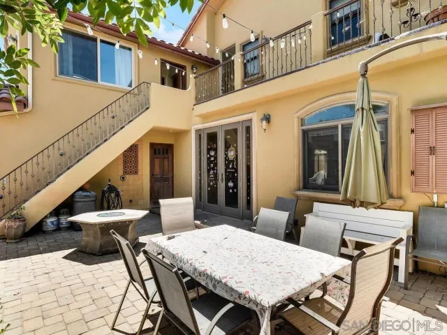 a view of a patio with table and chairs