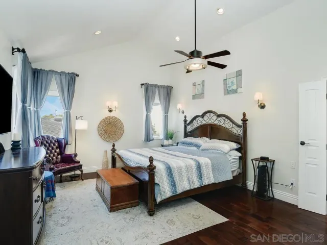 a bedroom with bed and a chandelier