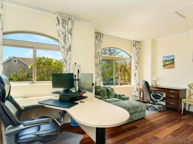 a view of a workspace with furniture and a window