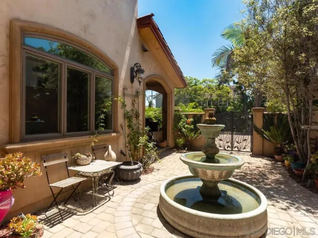 a view of a house with backyard fountain and a fountain