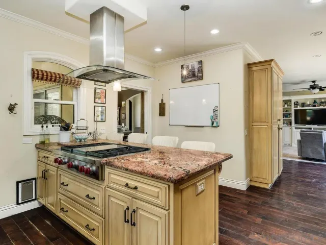 a kitchen with a stove a refrigerator and wooden cabinets