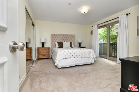 a bedroom with a bed and ceiling fan