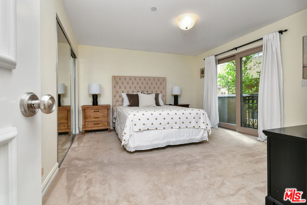 15248 Clark Street, Unit 104 Sherman Oaks, CA 91411 - Photo 19 of 48 a bedroom with a bed and ceiling fan