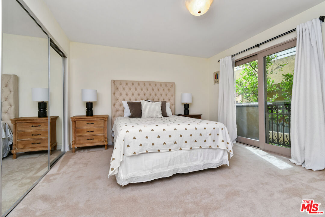 15248 Clark Street, Unit 104 Sherman Oaks, CA 91411 - Photo 21 of 48 a bedroom with a bed and a large window