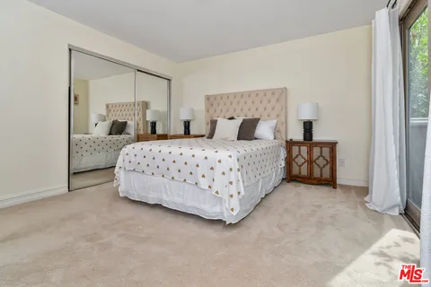 a bedroom with a bed and a cabinets