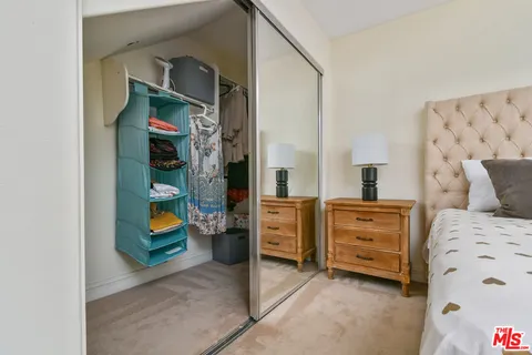 a bedroom with bed and cabinets