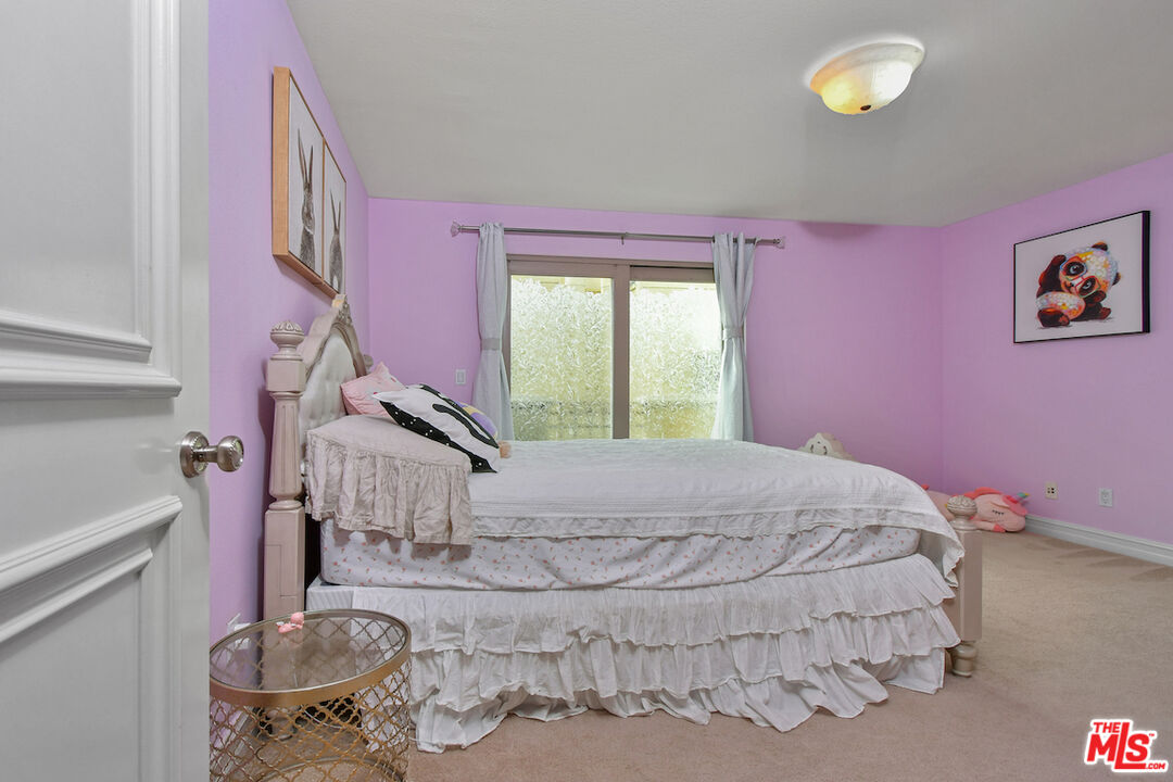 15248 Clark Street, Unit 104 Sherman Oaks, CA 91411 - Photo 29 of 48 a bedroom with a bed and a chandelier