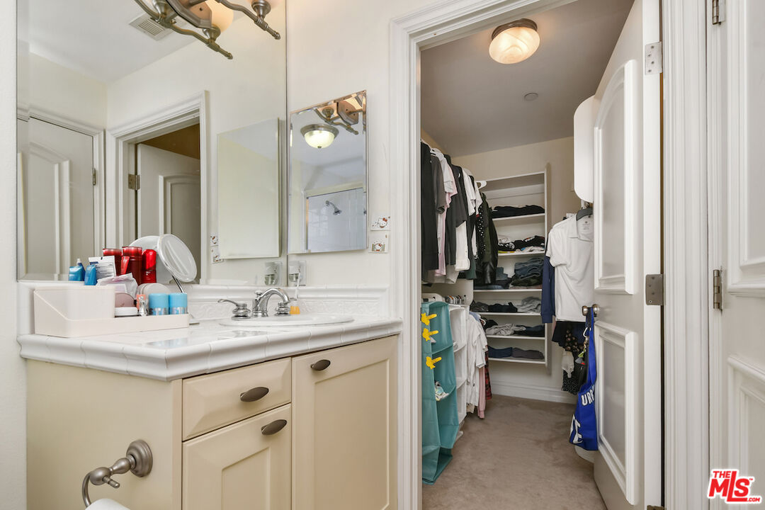 15248 Clark Street, Unit 104 Sherman Oaks, CA 91411 - Photo 35 of 48 a bathroom with a sink vanity and a mirror