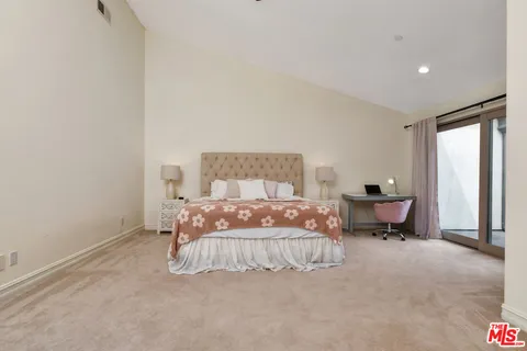 a bedroom with a bed and dresser