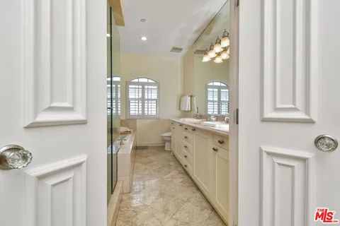 a bathroom with a sink vanity and a mirror