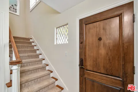 a view of entryway with wooden floor and stairs