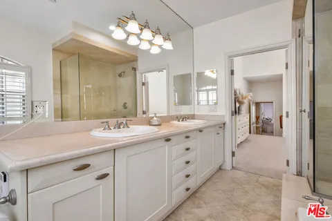 a bathroom with a tub sink and mirror