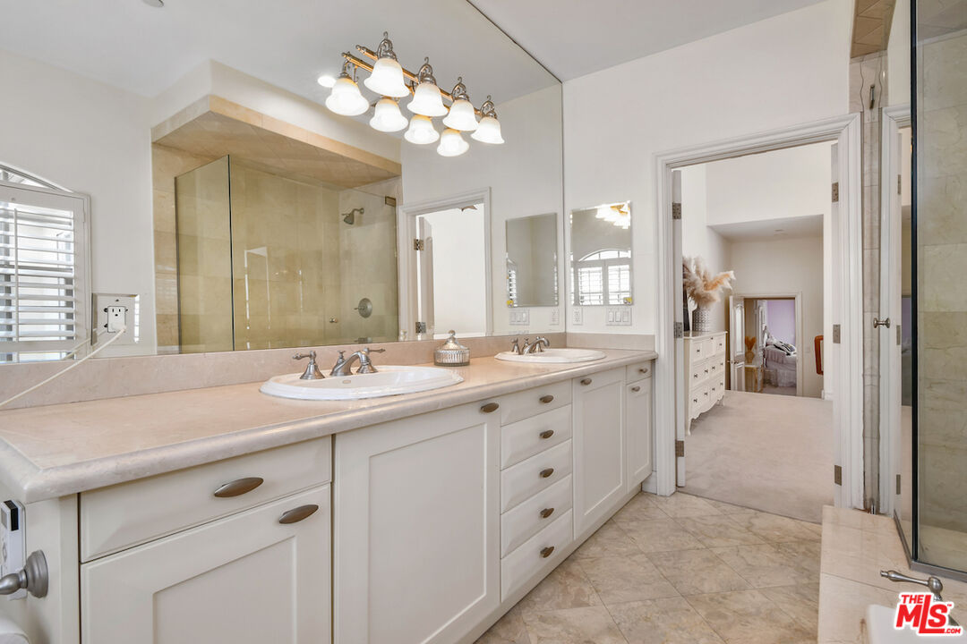 15248 Clark Street, Unit 104 Sherman Oaks, CA 91411 - Photo 41 of 48 a bathroom with a sink vanity and a mirror