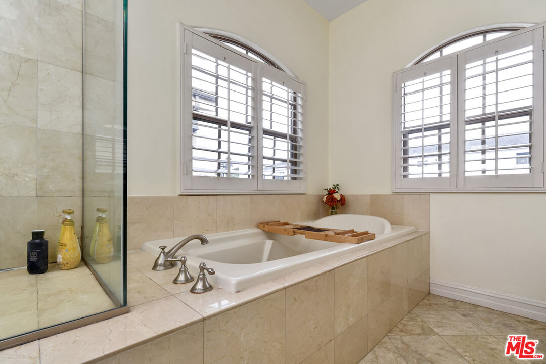 15248 Clark Street, Unit 104 Sherman Oaks, CA 91411 - Photo 42 of 48 a bathroom with a tub sink and mirror