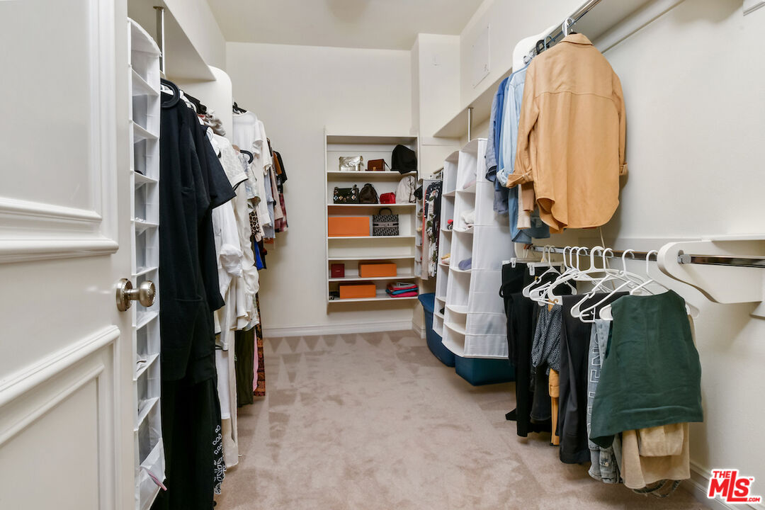 15248 Clark Street, Unit 104 Sherman Oaks, CA 91411 - Photo 44 of 48 a view of walk in closet with clothes and shoes