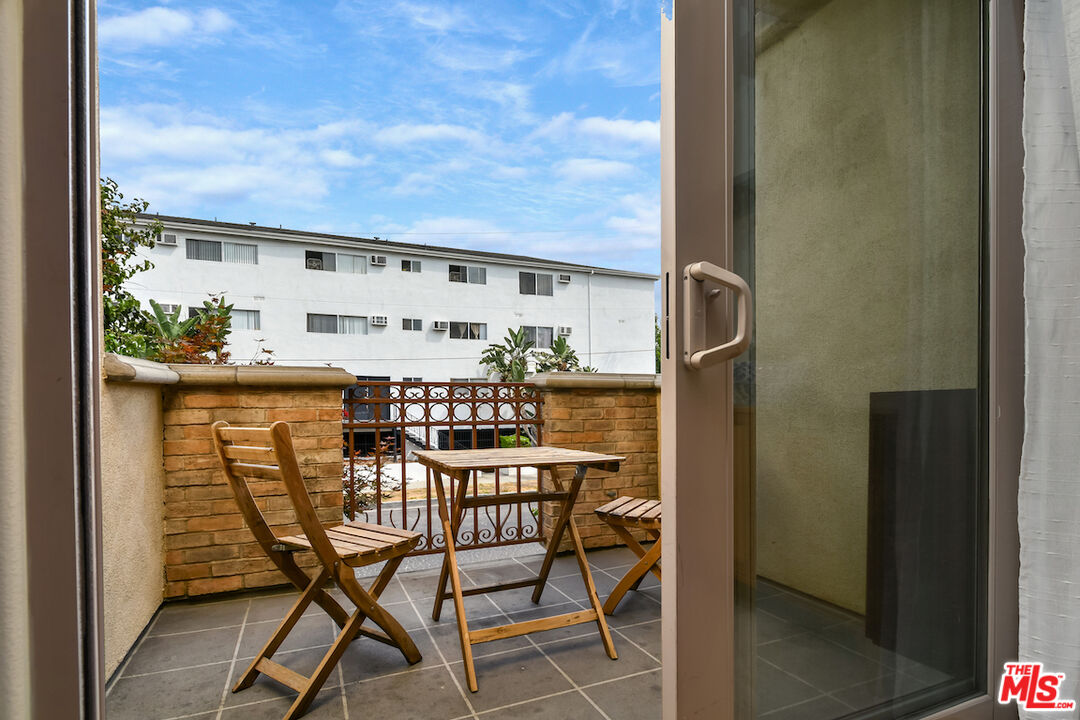 15248 Clark Street, Unit 104 Sherman Oaks, CA 91411 - Photo 9 of 48 a view of a chairs and table in a balcony