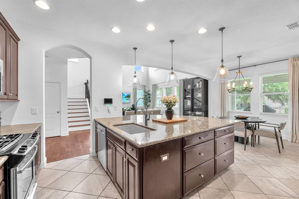 5310 Fishhawk Ridge Drive Lithia, FL 33547 - Photo 14 of 52 a kitchen with a sink stove and wooden cabinets