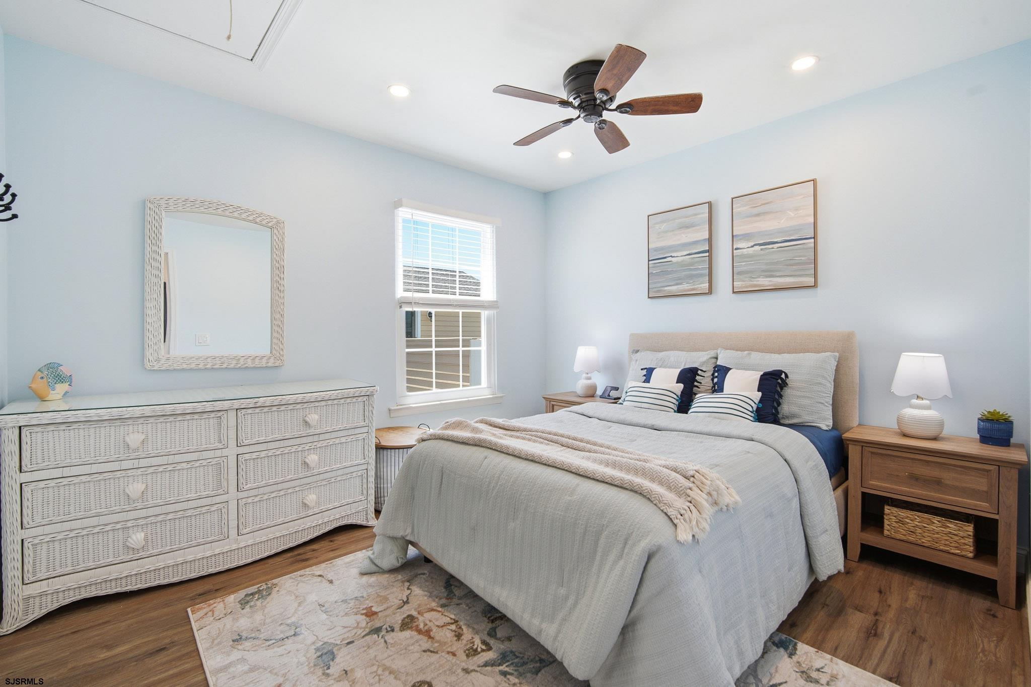 214 Hagen Road Brigantine, NJ 08203 - Photo 20 of 34 a bedroom with a bed and a chandelier