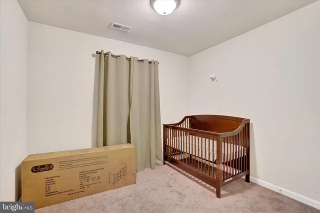 a view of a bedroom with wooden floor