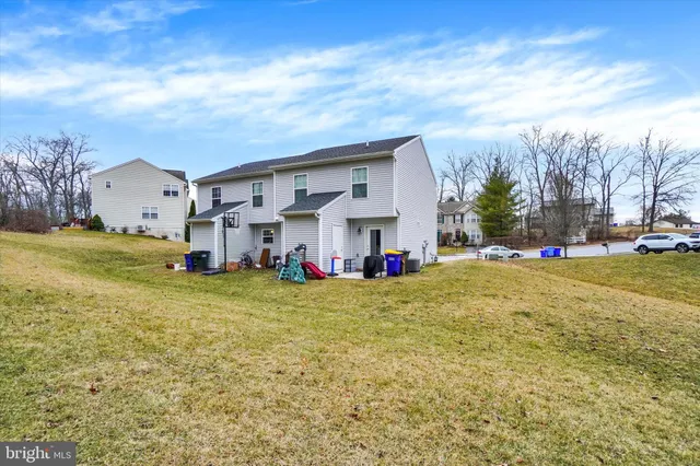 a front view of house with yard and trees