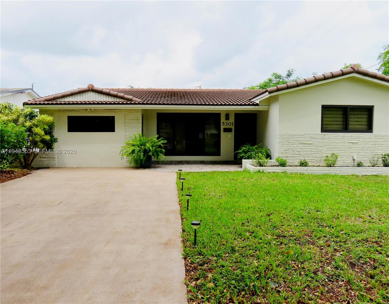 a front view of house with yard and green space