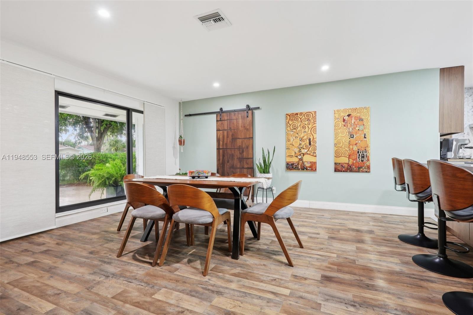 5301 Pierce Street Hollywood, FL 33021 - Photo 13 of 45 a dining room with furniture and wooden floor