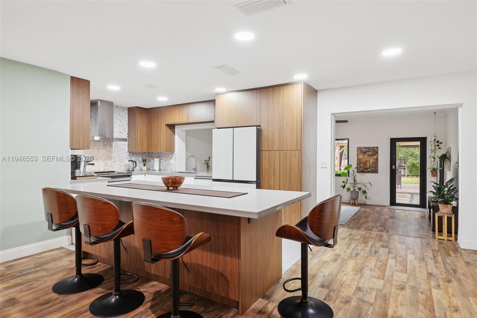 5301 Pierce Street Hollywood, FL 33021 - Photo 15 of 45 a kitchen with stainless steel appliances granite countertop a dining table chairs and granite counter tops