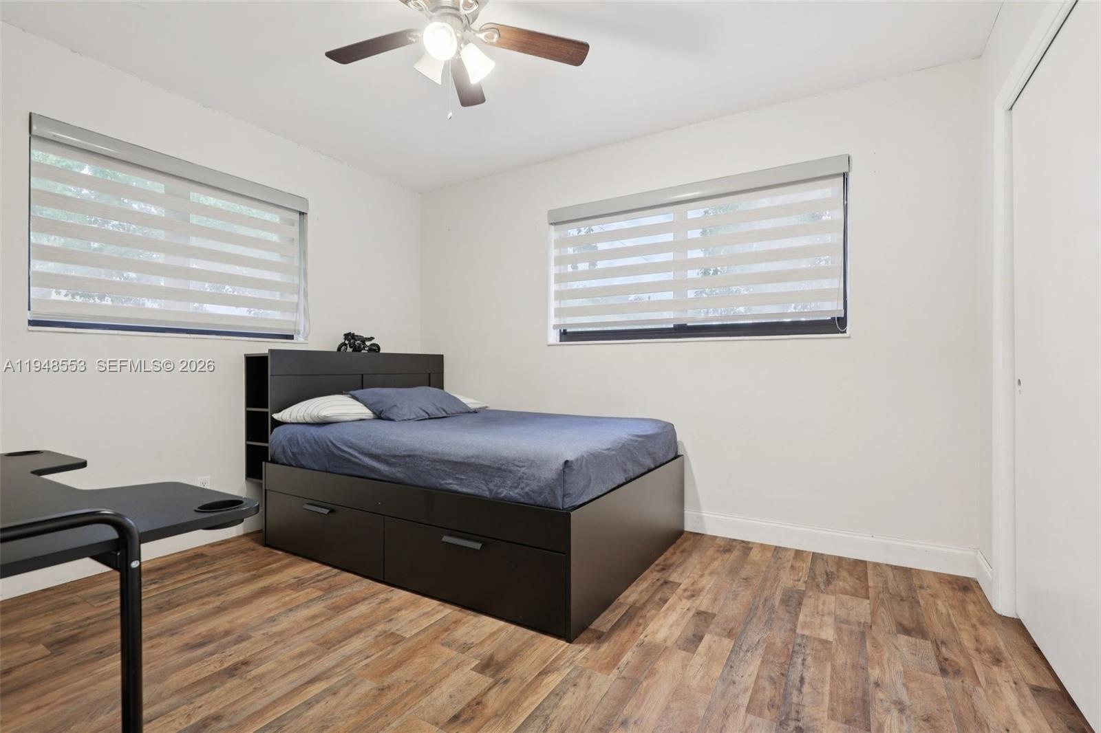 5301 Pierce Street Hollywood, FL 33021 - Photo 19 of 45 a bedroom with a bed and wooden floor