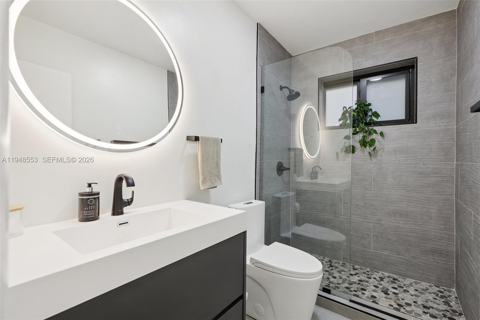 5301 Pierce Street Hollywood, FL 33021 - Photo 23 of 45 a bathroom with a sink a toilet and a mirror