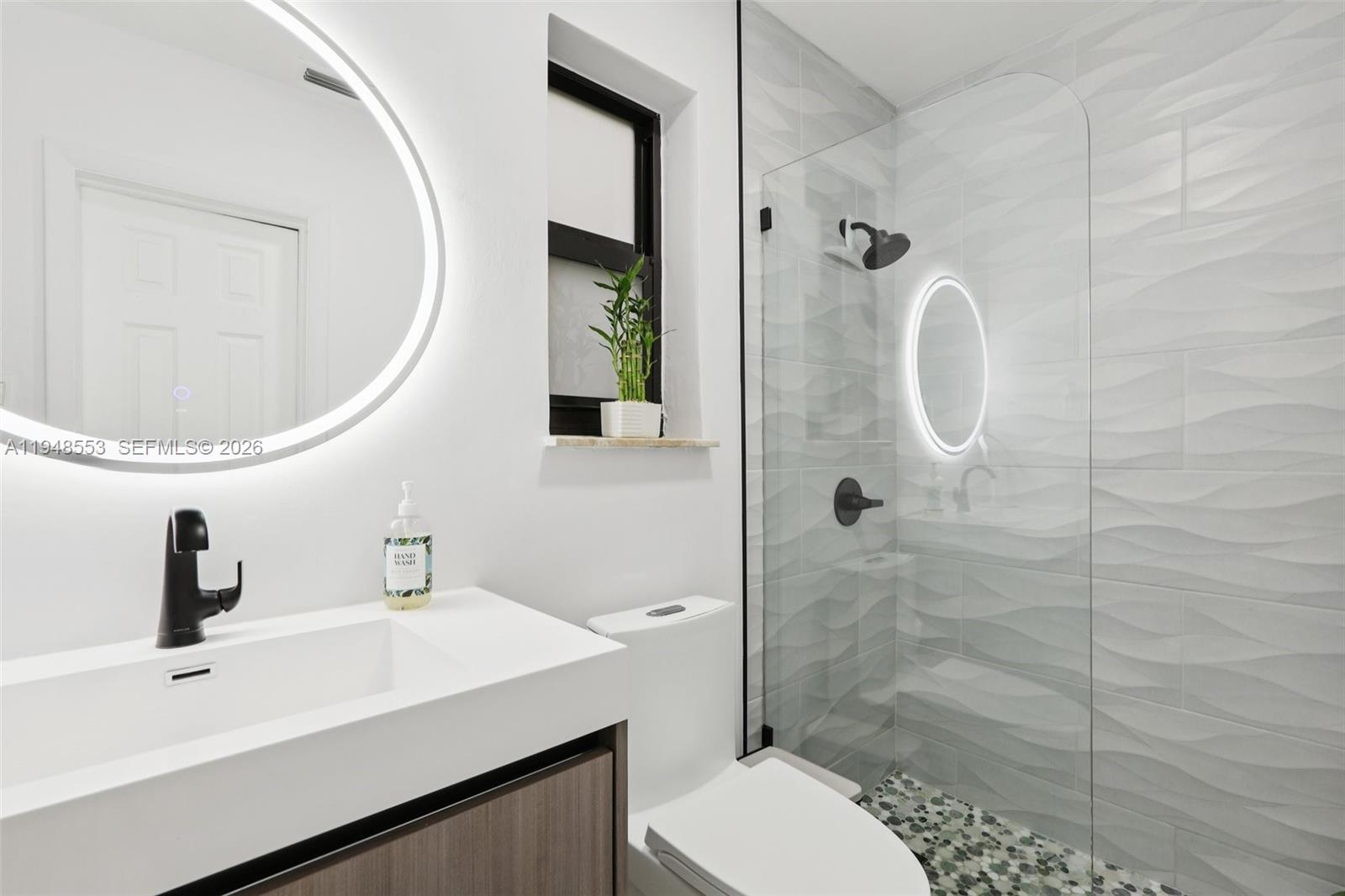 5301 Pierce Street Hollywood, FL 33021 - Photo 29 of 45 a bathroom with a sink a toilet and shower