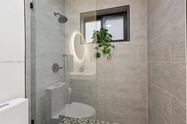 a bathroom with a toilet and a shower