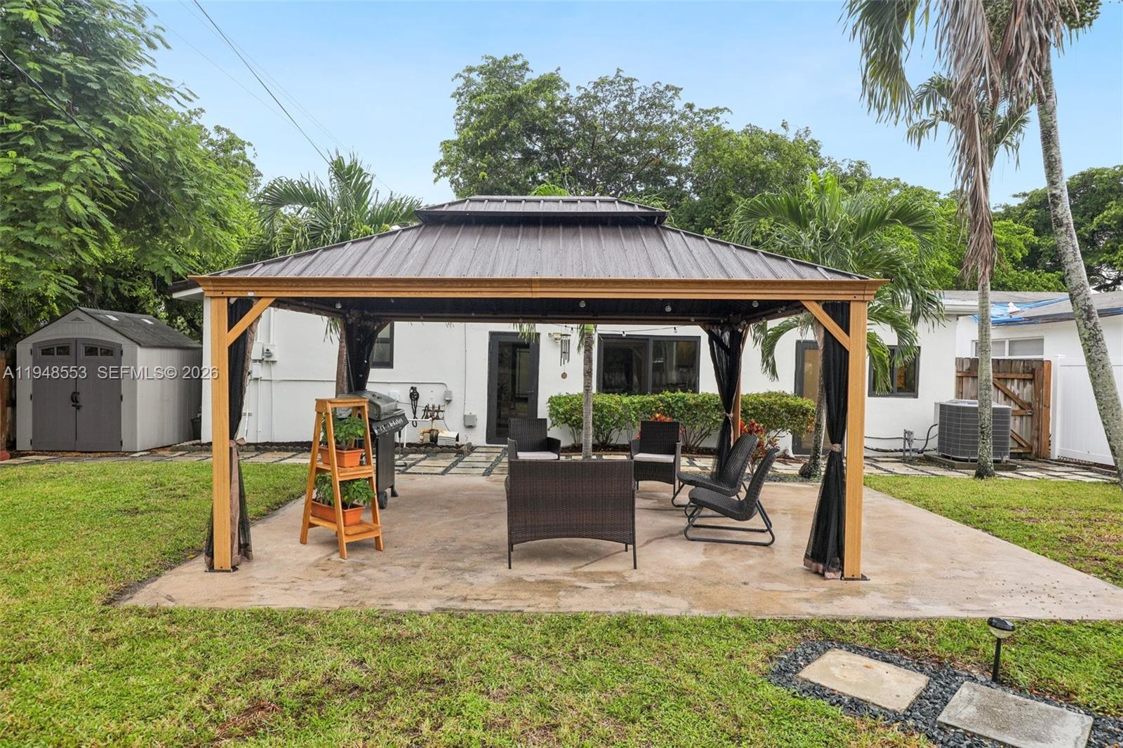 5301 Pierce Street Hollywood, FL 33021 - Photo 39 of 45 a view of a house with backyard sitting area and garden
