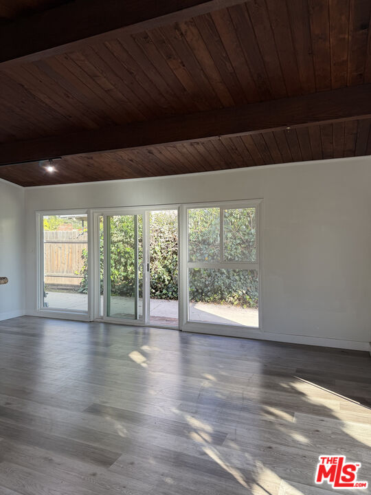281 Stanton Street, Unit 1 Pasadena, CA 91103 - Photo 5 of 9 a view of an empty room with wooden floor and a window